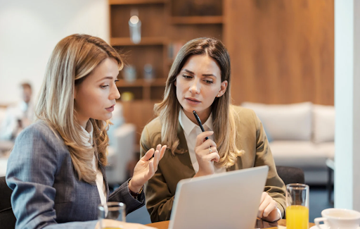 two women strategizing on a business operations project